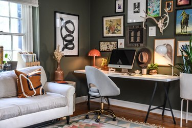 corner home office in gray room with gallery wall